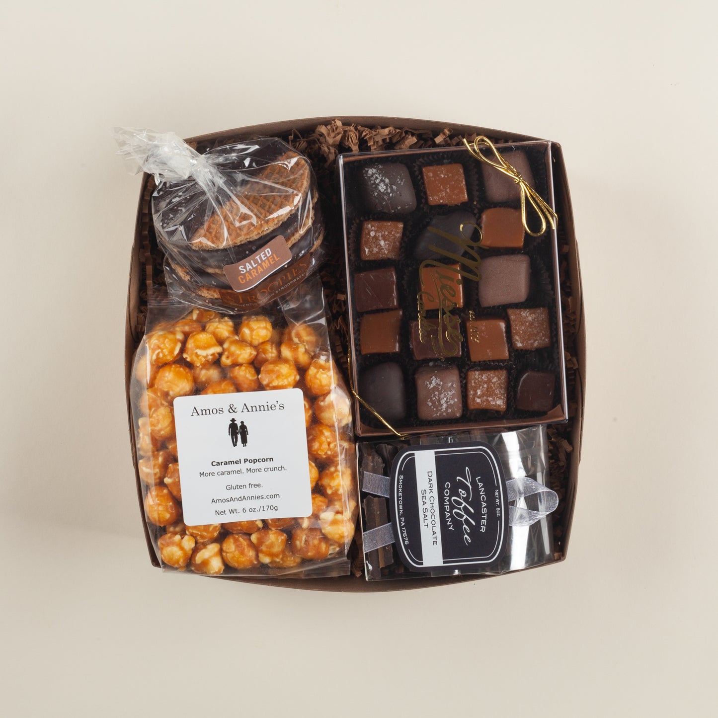 Buttery, salty-sweet Pennsylvania gift box with crunchy caramel popcorn, velvety caramels, rich dark chocolate toffee & salted caramel stroopwafels.