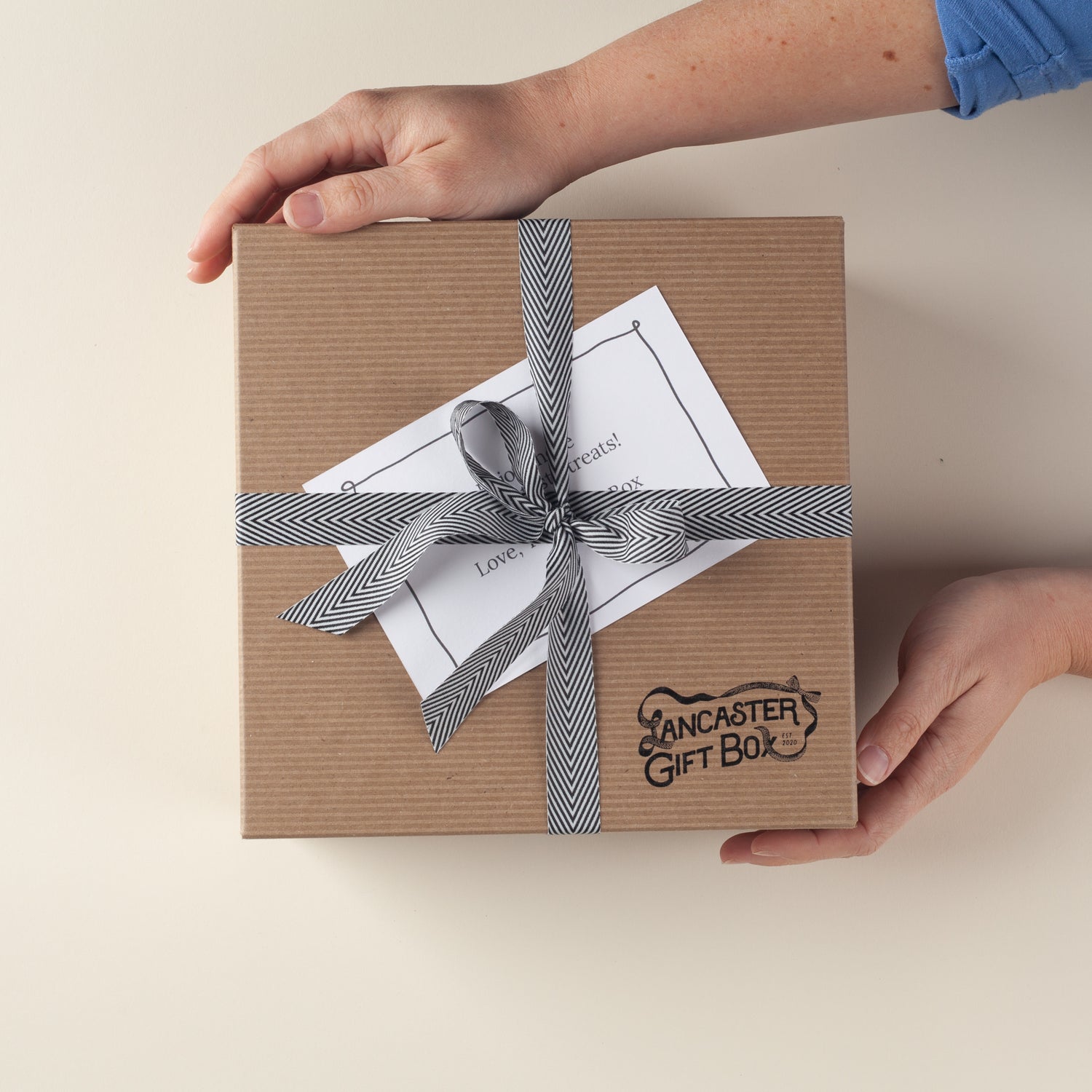 Lancaster Gift Box kraft gift box with hand-tied herringbone bow and complimentary gift message notecard, ships ready to gift.