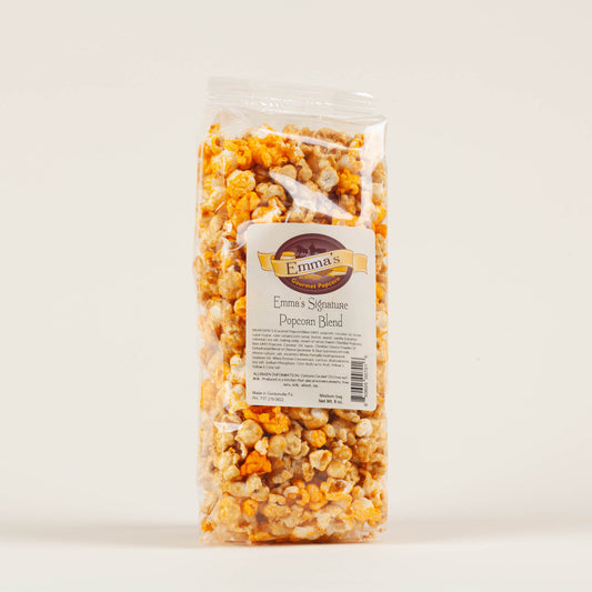 Medium bag of Emma's Signature Cheddar and Caramel popcorn on a light background, small-batch non-GMO popcorn made in Gordonville, Lancaster County, PA.