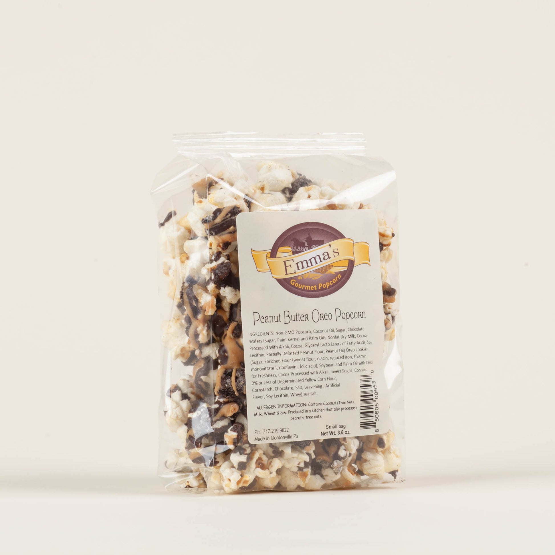 Small bag of Emma's Peanut Butter Oreo popcorn on a light background, chocolate-drizzled popcorn with crushed Oreo cookies and sea salt, made in Lancaster County, PA.