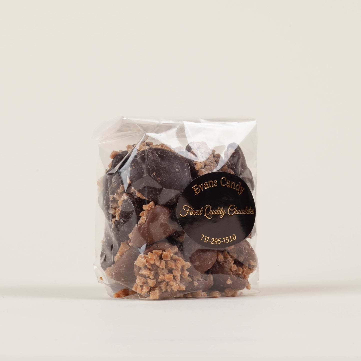 Eight-ounce bag of Evans Candy Toffee Nonpareils on a light background, mixed milk and dark chocolate toffee nonpareils handmade in Lancaster, PA.