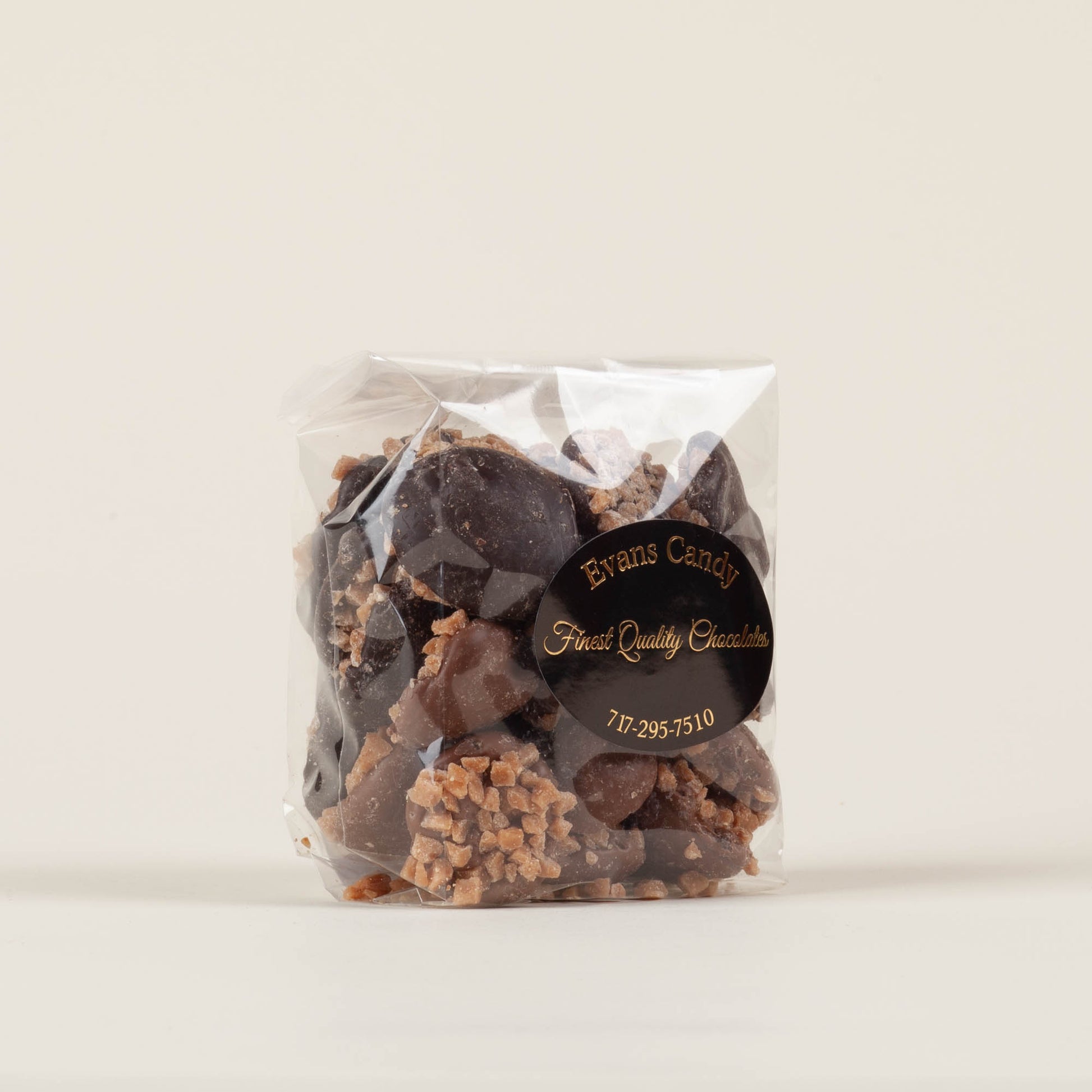 Eight-ounce bag of Evans Candy Toffee Nonpareils on a light background, mixed milk and dark chocolate toffee nonpareils handmade in Lancaster, PA.