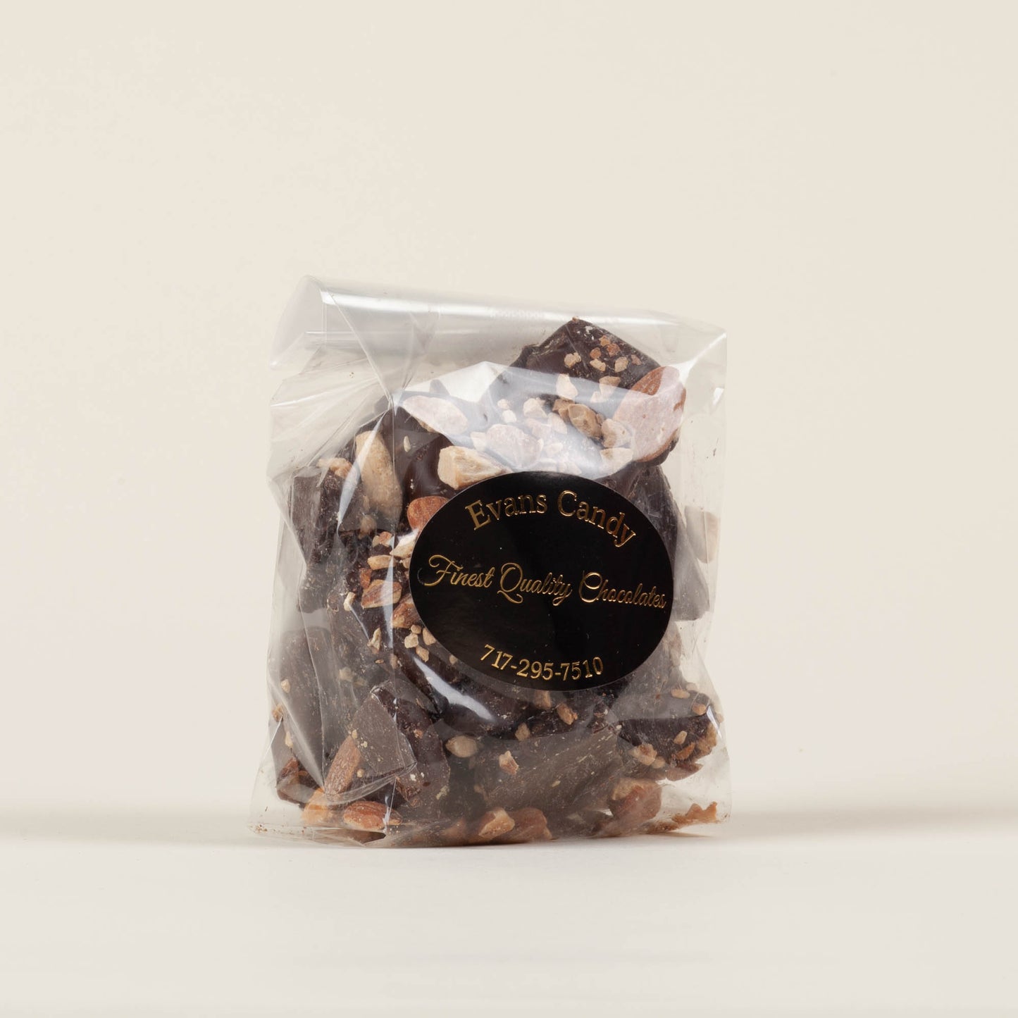 Eight-ounce bag of Evans Candy Dark Chocolate Almond Butter Crunch on a light background, handmade dark chocolate almond toffee crunch made in Lancaster, PA.