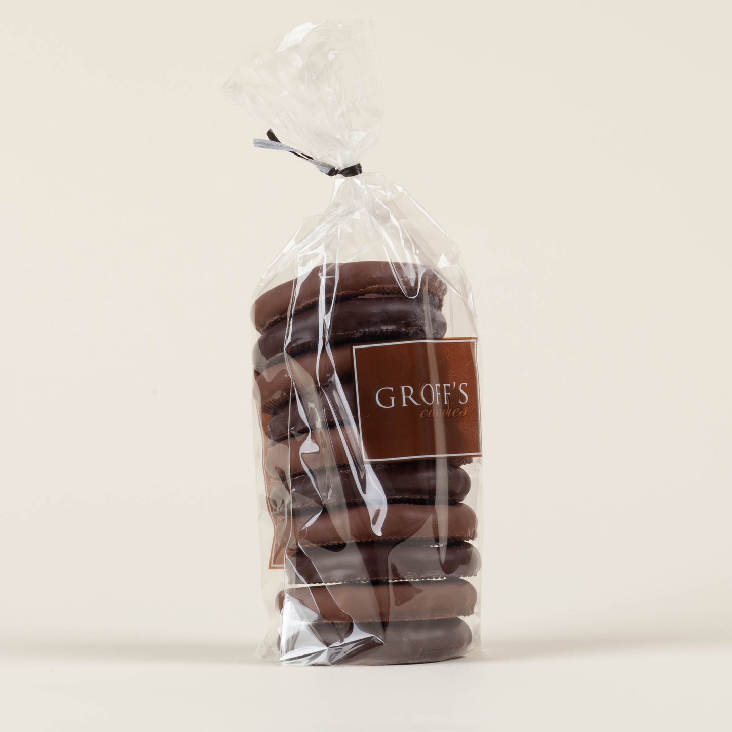 Eight-ounce bag of Groff's Candies mixed milk and dark chocolate covered pretzels on a cream background, handmade by third-generation candy makers in Lancaster, PA