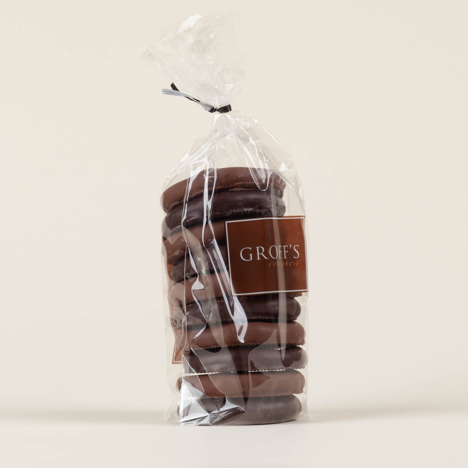 Eight-ounce bag of Groff's Candies mixed milk and dark chocolate covered pretzels on a cream background, handmade by third-generation candy makers in Lancaster, PA
