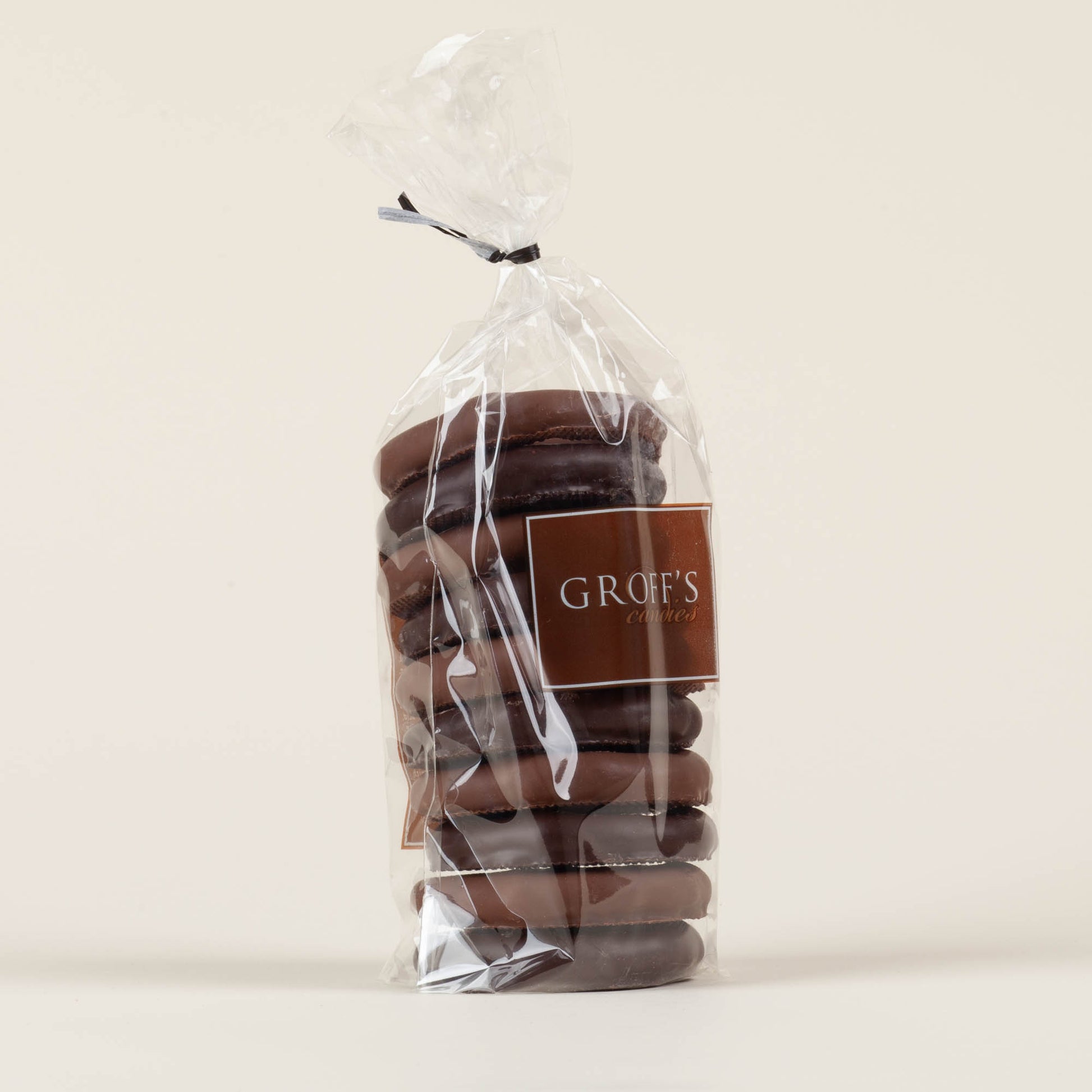 Eight-ounce bag of Groff's Candies mixed milk and dark chocolate covered pretzels on a cream background, handmade by third-generation candy makers in Lancaster, PA