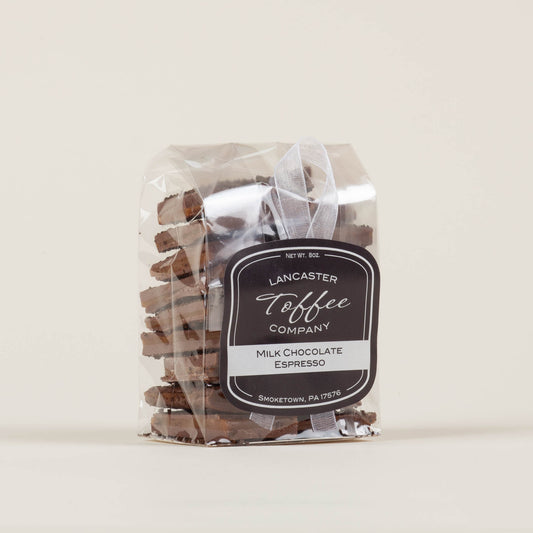 Eight-ounce bag of Lancaster Toffee Co. Espresso Milk Chocolate Toffee on a light background, English-style toffee with milk chocolate and ground espresso made in Lancaster, PA.