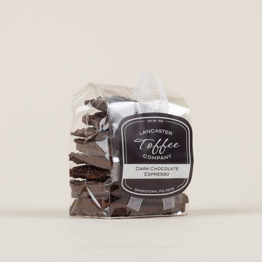 Eight-ounce bag of Lancaster Toffee Co. Espresso Dark Chocolate Toffee on a light background, English-style toffee with dark chocolate and ground espresso made in Lancaster, PA.