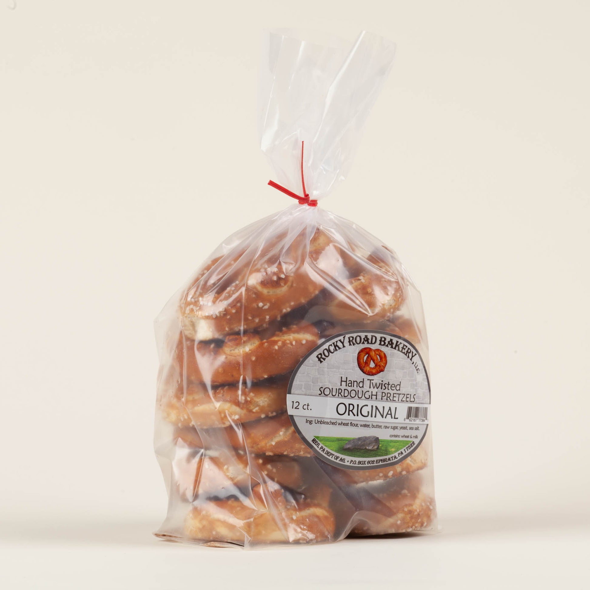 12-pack of Rocky Road Bakery hand-twisted sourdough pretzels on a light background, buttery small-batch hard pretzels made on a Mennonite family farm in Ephrata, Lancaster County, PA.