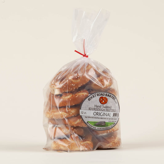 12-pack of Rocky Road Bakery hand-twisted sourdough pretzels on a light background, buttery small-batch hard pretzels made on a Mennonite family farm in Ephrata, Lancaster County, PA.
