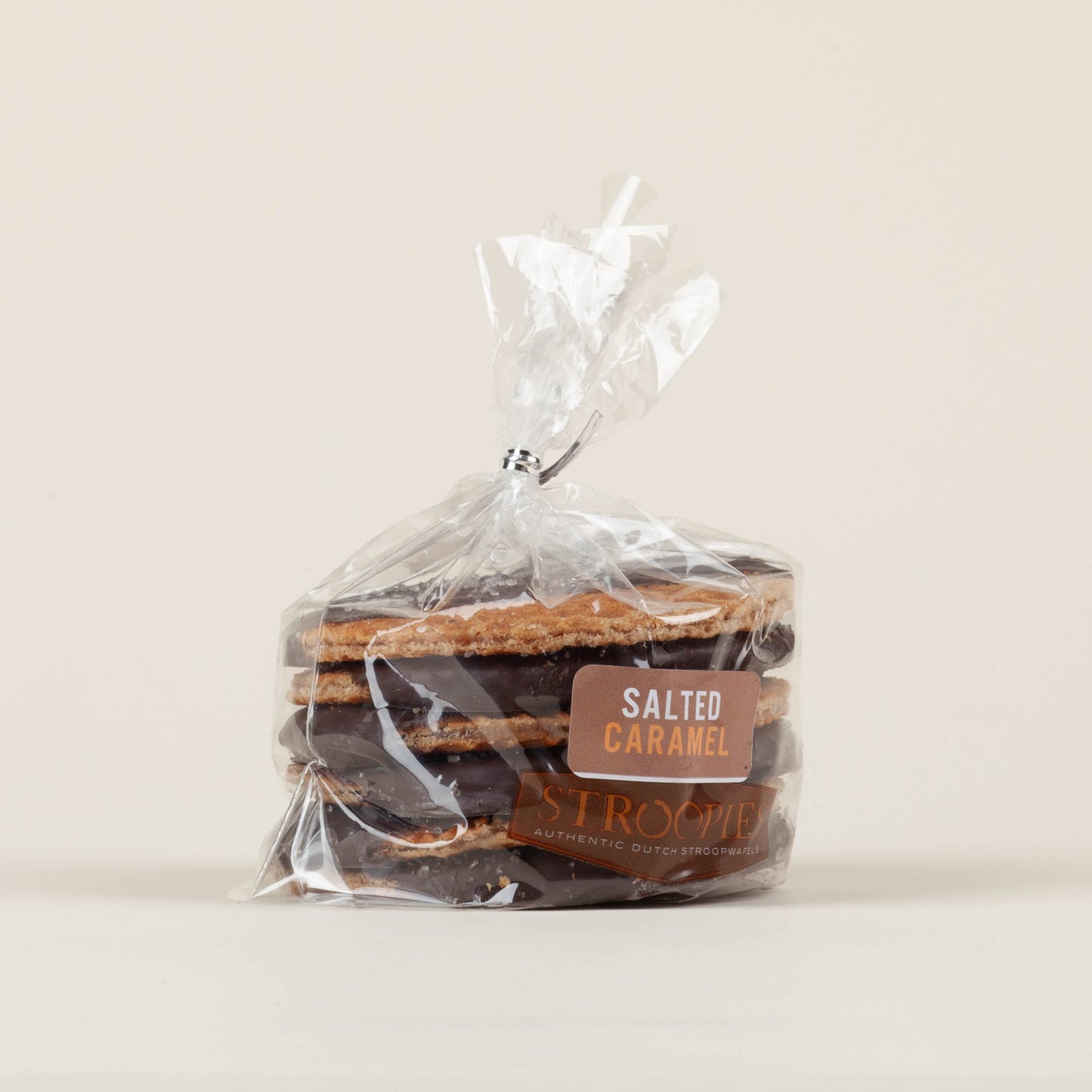 Gift pack of six salted caramel chocolate-dipped Stroopies stroopwafels on a white background, round caramel-filled waffle cookies coated in dark chocolate, made in Lancaster, PA.