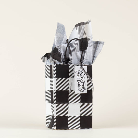 Lancaster Gift Box event bag in signature black and white gingham with gift tag on a light background. 