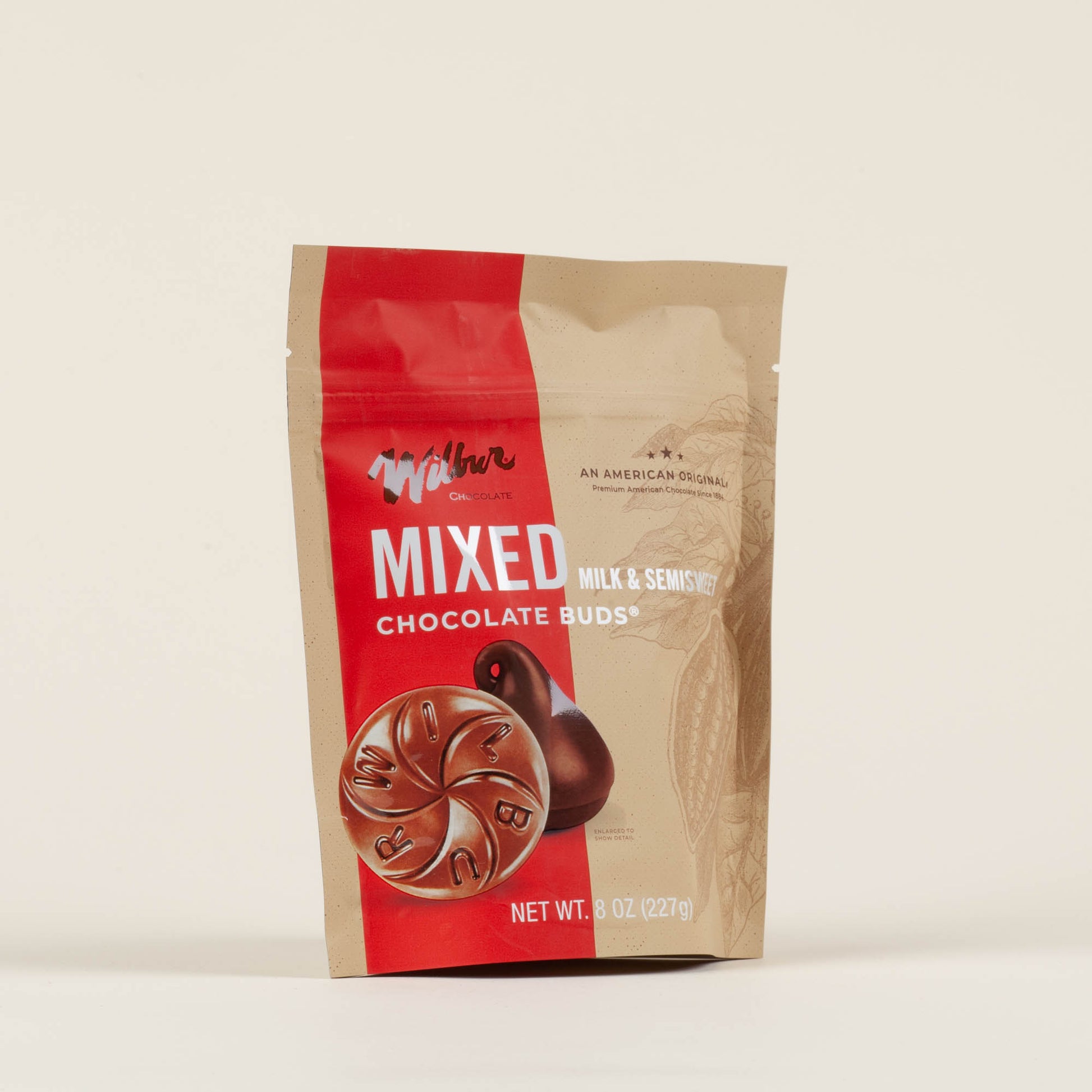 Eight-ounce bag of Wilbur Mixed Milk and Semi-Sweet Chocolate Buds on a light background, premium conical chocolate drops made in Lititz, PA since 1894, predating the Hershey Kiss by over a decade.